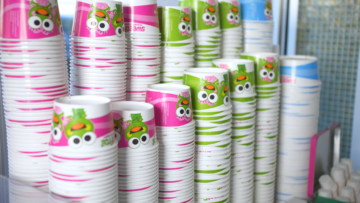 sweetfrog franchise owner stacks of frozen yogurt cups