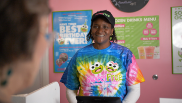 sweetFrog employee smiles at customer