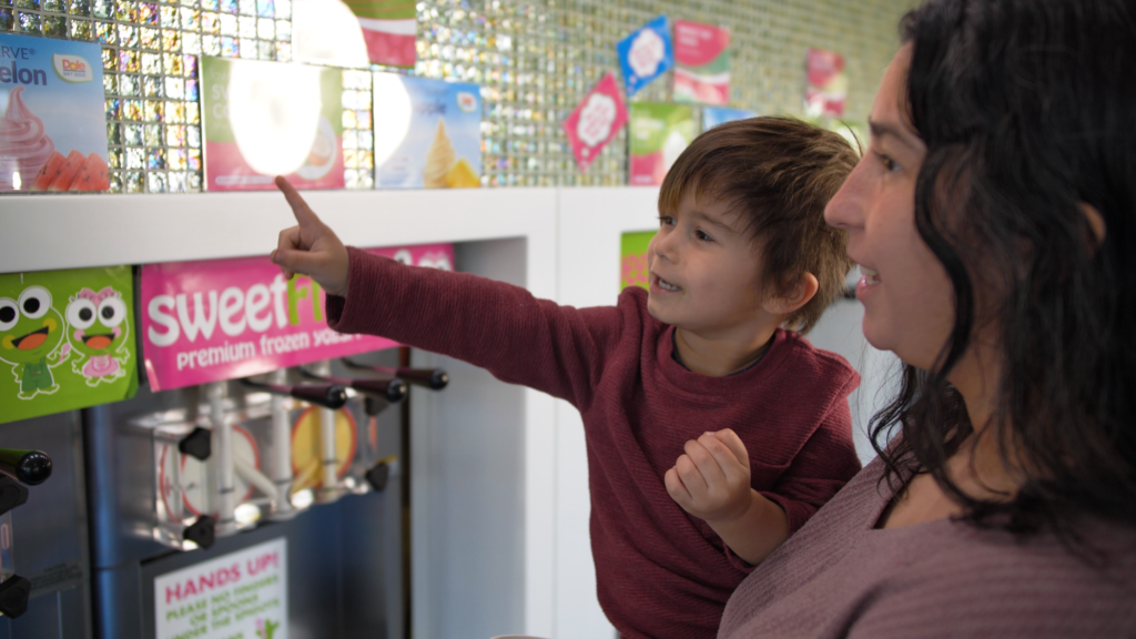 happy customers pointing at treat options