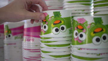 hand reaching for frozen yogurt cup